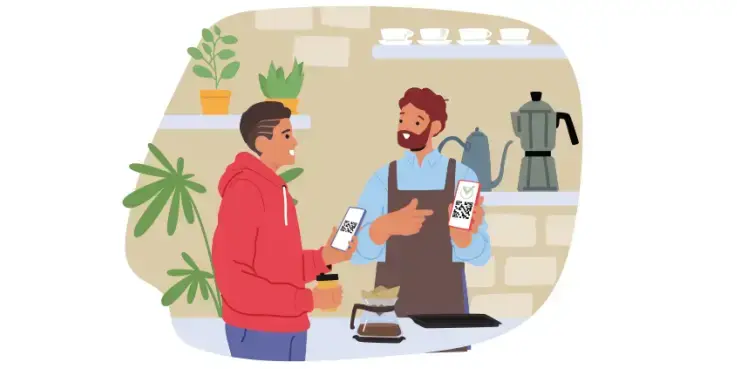 Osoba w czerwonej bluzie z kapturem płaci za pomocą WERO, używając kodu QR, w kawiarni.