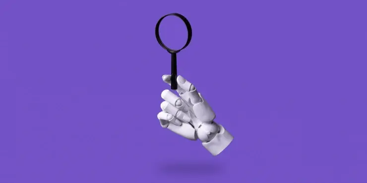 ręka robota trzymająca lupę symbolizująca wyszukiwarki AI